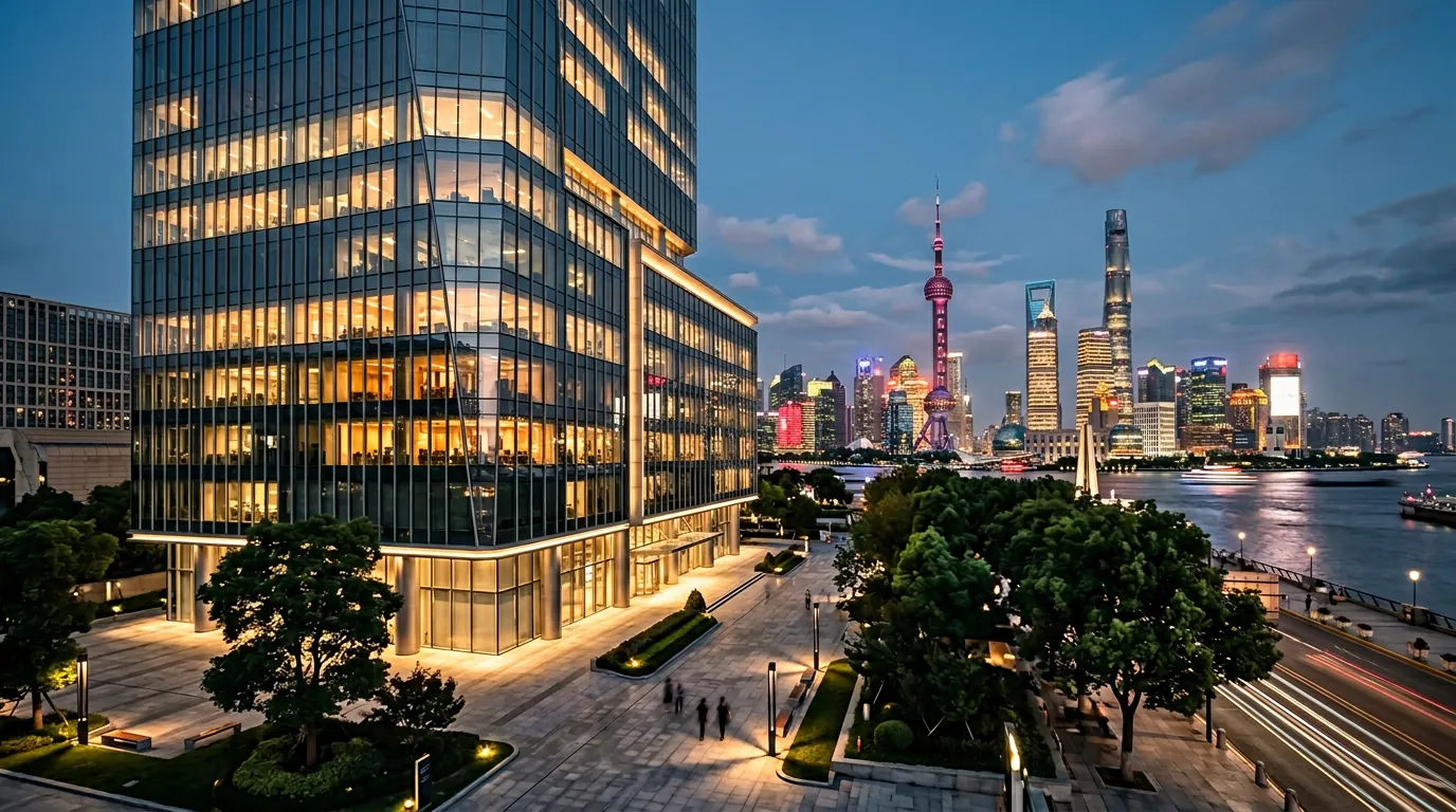 Stella's Pudong office building at dusk with the Shanghai skyline behind it